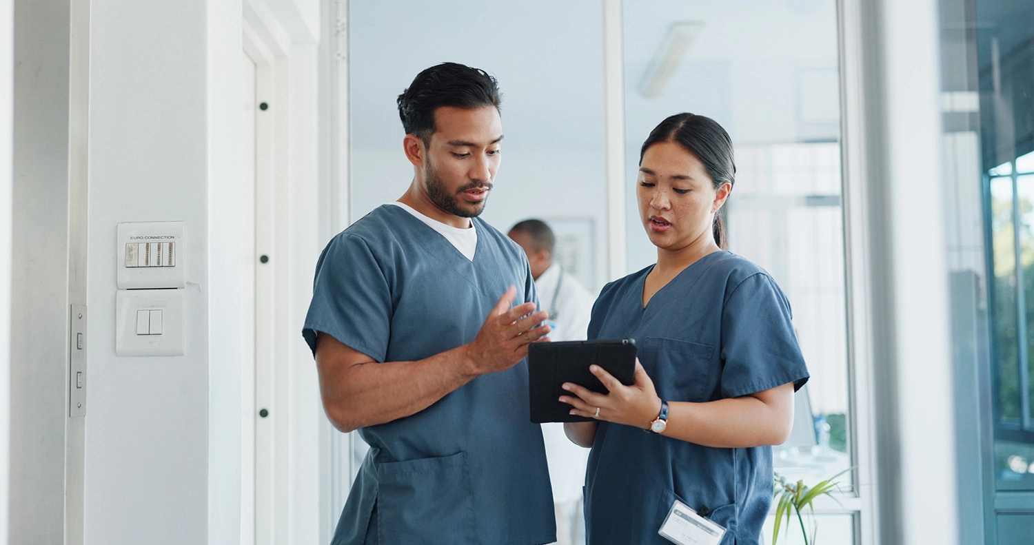 Healthcare professionals reviewing information on a tablet